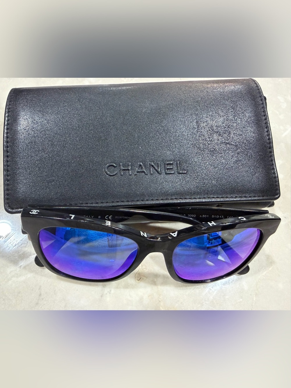 CHANEL Black Frame Sunglasses with Blue-Purple Mirrored Lenses